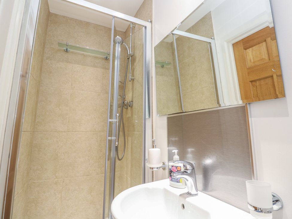 A bathroom with a shower and sink at Ash Barn in Falmouth