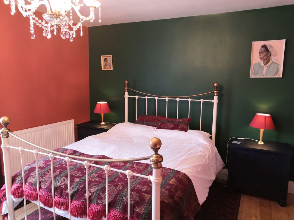 A bedroom with a bed and nightstand at 33 High Street Fortuneswell