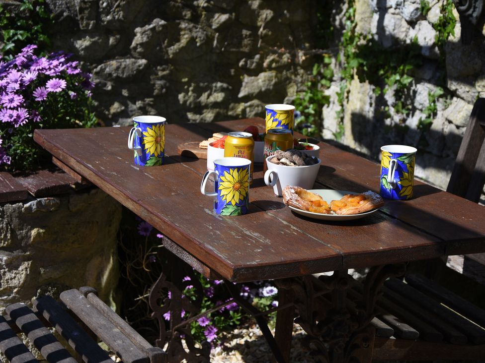 A table with mugs and food items at 33 High Street Fortuneswell