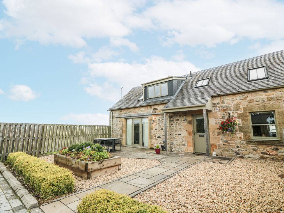 An outdoor view of a house with a garden at Thorneydyke Cottage Stirling