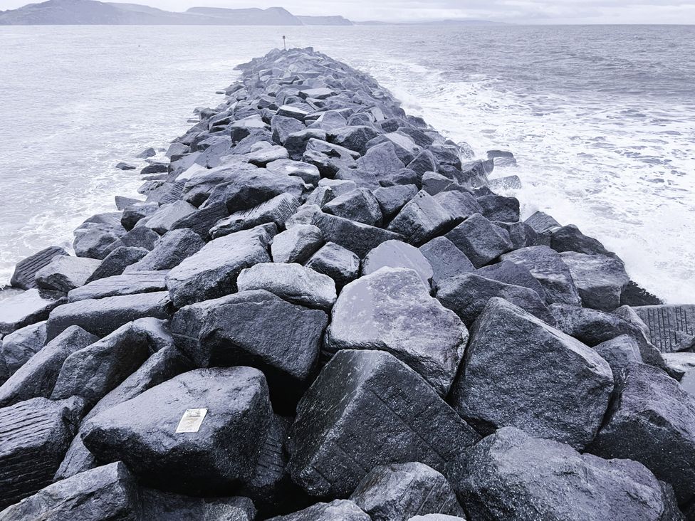 A rocky jetty extending into the water at Agua de Plata, 16 Wakeling Island, Silverlake Dorchester