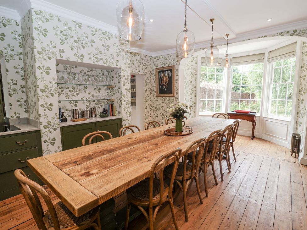 A dining room with a large wooden table and chairs at Syleham House in Syleham near Eye