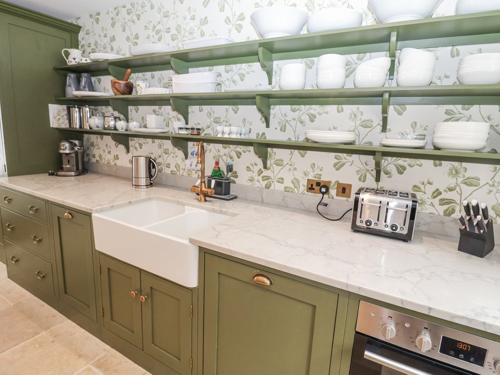 A kitchen with cabinets and open shelves at Syleham House in Syleham near Eye