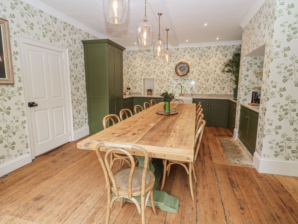 A kitchen with a wooden dining table and chairs at Syleham House Syleham near Eye