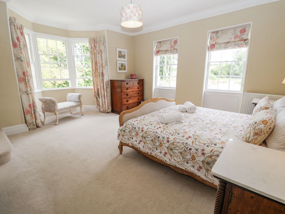 A bedroom with a bed and wardrobe at Syleham House in Syleham near Eye
