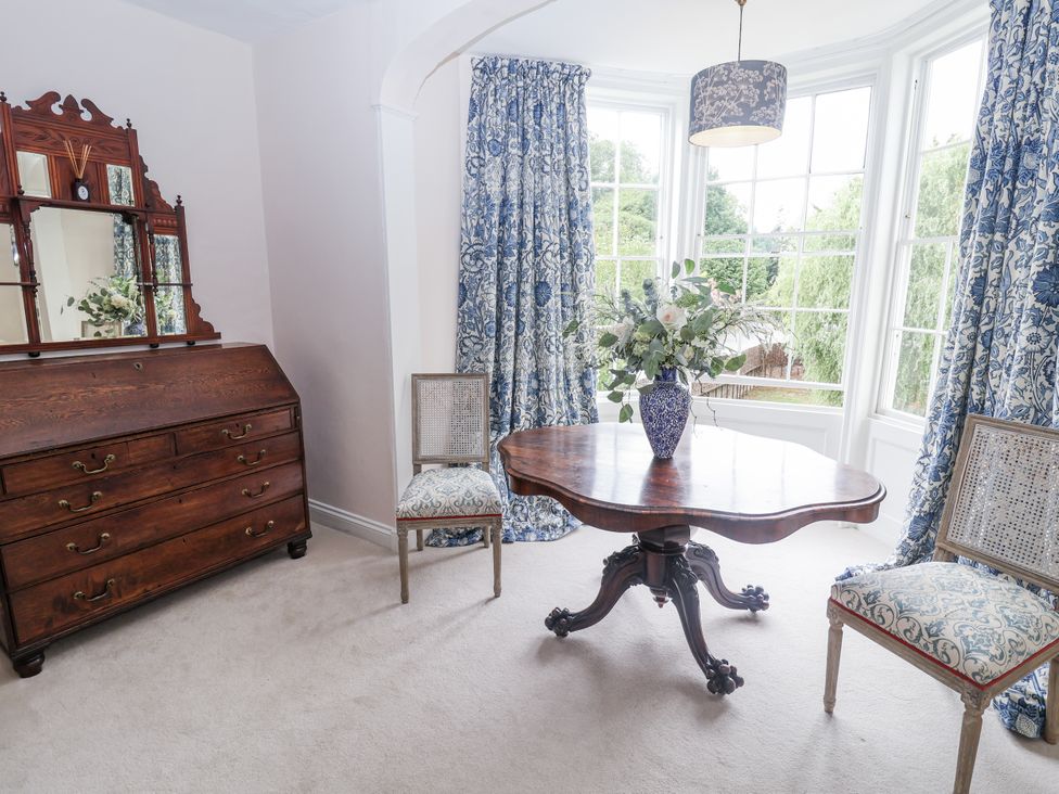 A sitting room with a table and chairs at Syleham House in Syleham near Eye