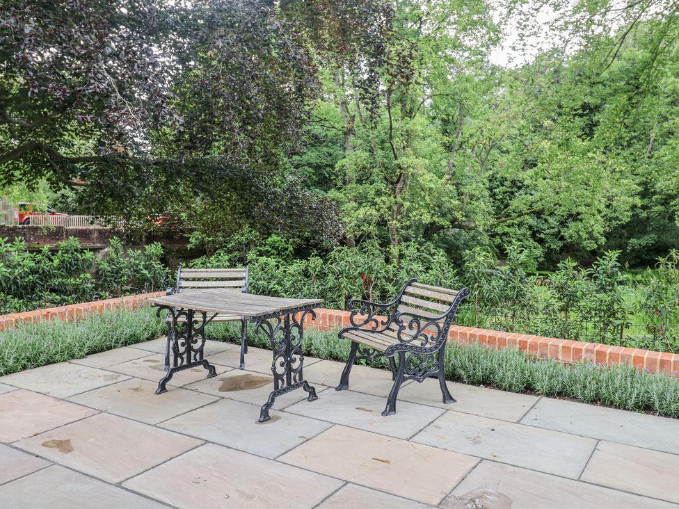 A table and two benches in a garden at Syleham House Syleham near Eye