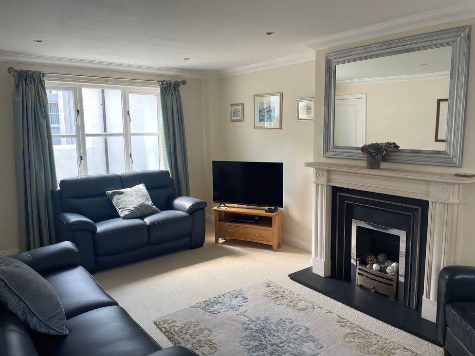 A living room with a television and sofa at 3 Strawberry Close Little Haven near Broad Haven