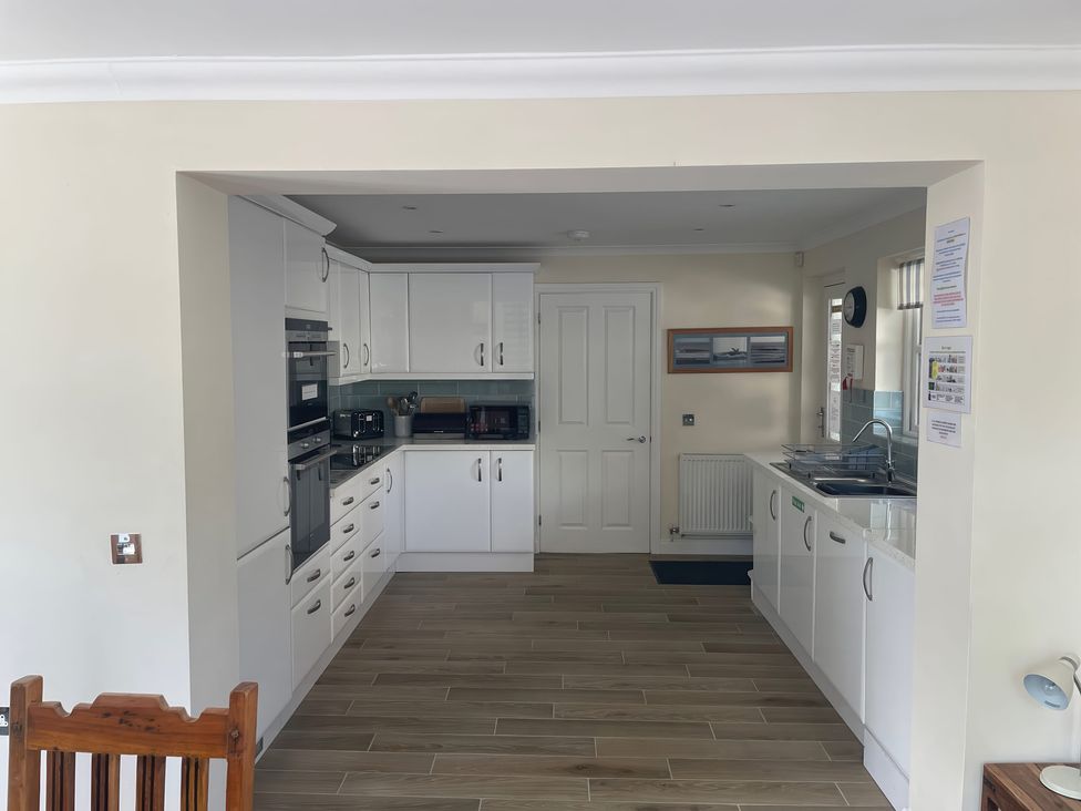 A kitchen with cabinets and appliances at 3 Strawberry Close Little Haven near Broad Haven