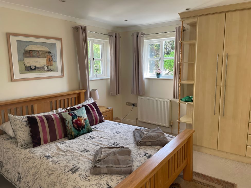 A bedroom with a bed and wardrobe at 3 Strawberry Close Little Haven near Broad Haven