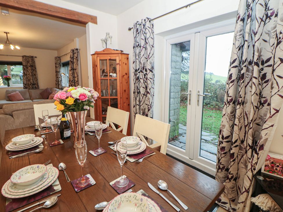A dining room with a table set for a meal at The Beeches Aldwark near Winster