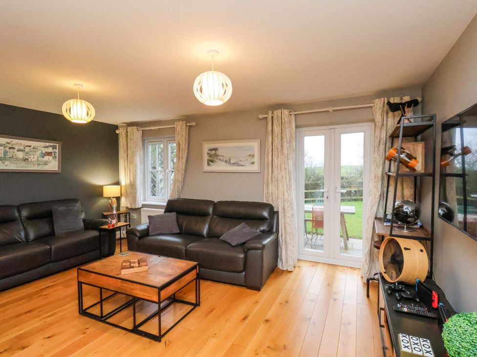 A living room with sofas and a table at The Beach Retreat in The Bay - Filey