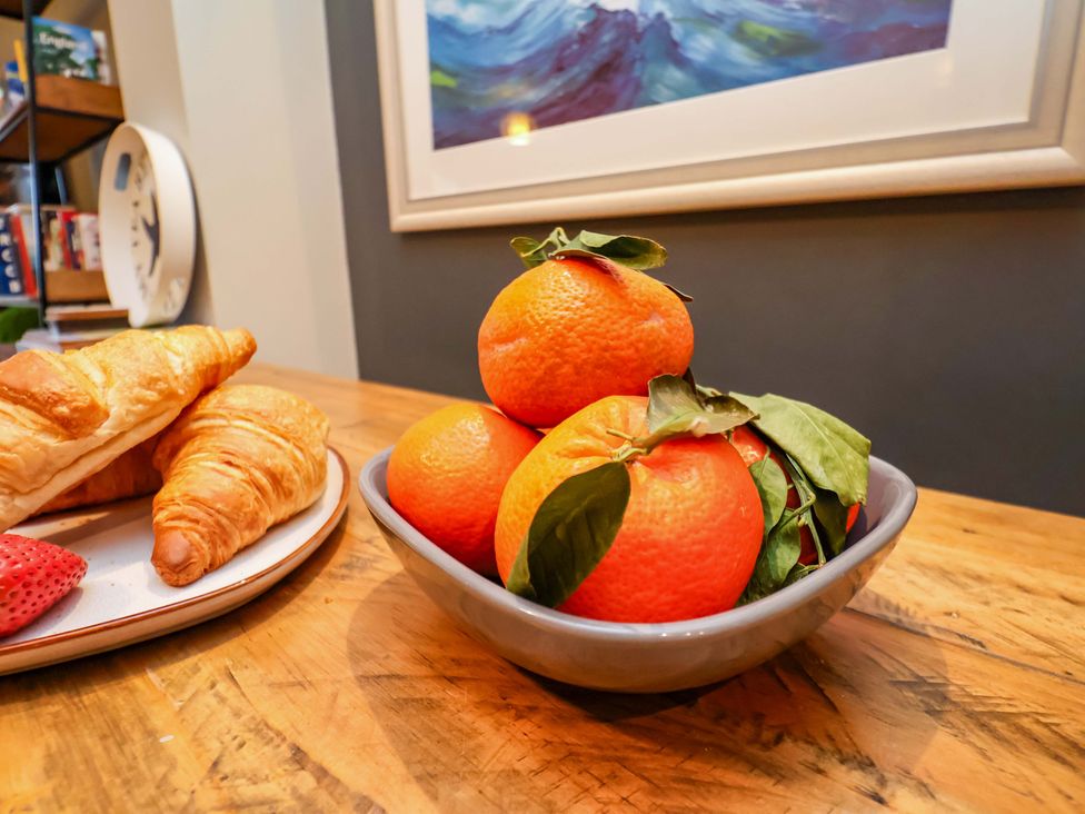 A bowl of oranges with croissants and a strawberry at The Beach Retreat The Bay - Filey
