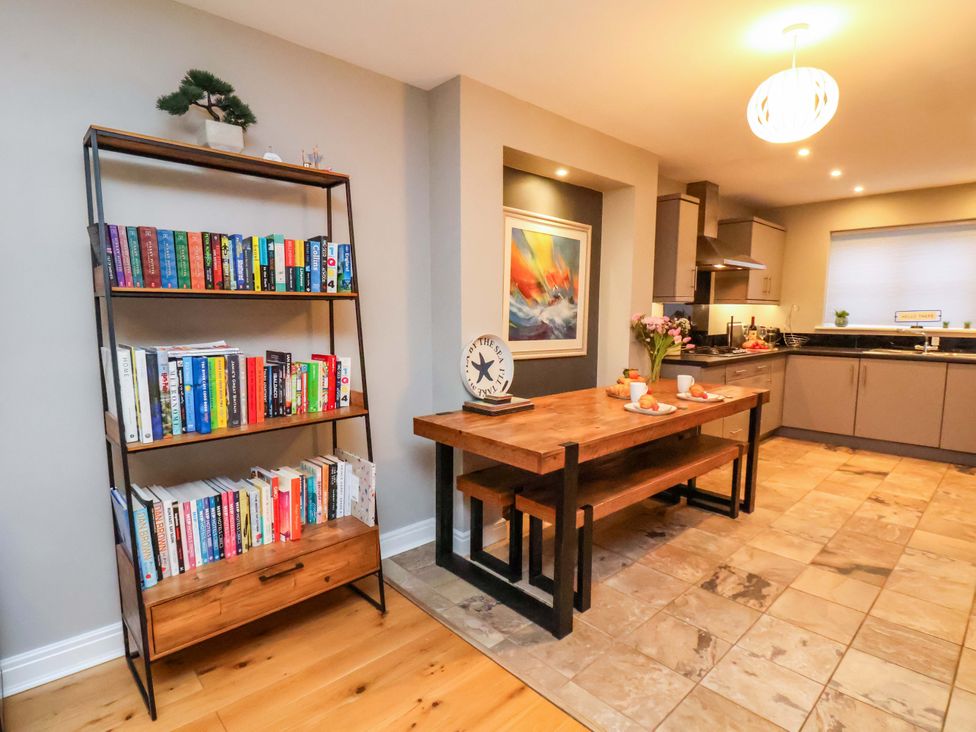 A dining room with a table and bookshelf at The Beach Retreat in The Bay - Filey