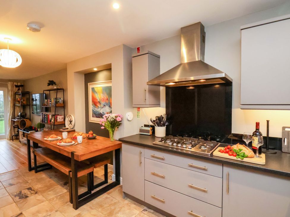 A kitchen with a dining table and cooking area at The Beach Retreat in The Bay - Filey