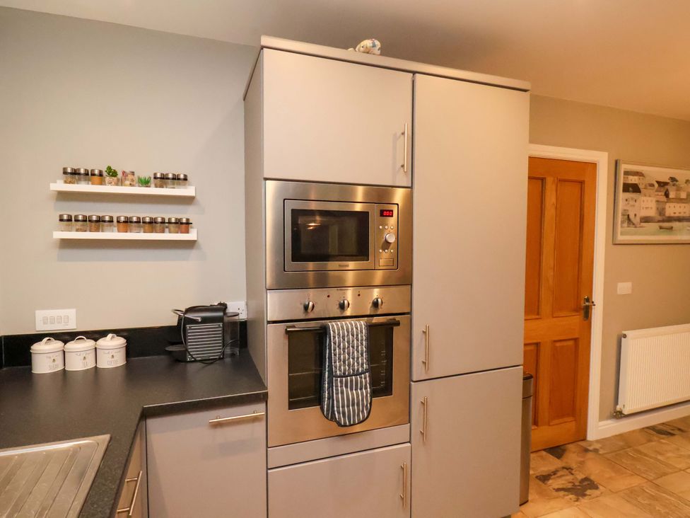 A kitchen with an oven and microwave at The Beach Retreat in The Bay - Filey