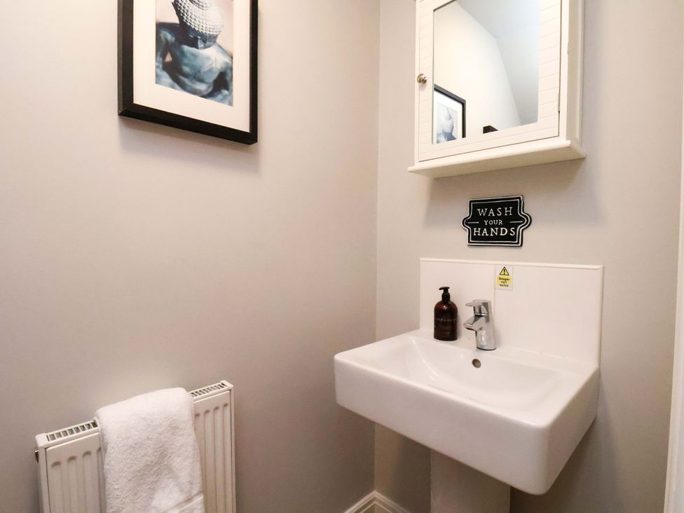 A bathroom with a sink and mirror at The Beach Retreat The Bay - Filey