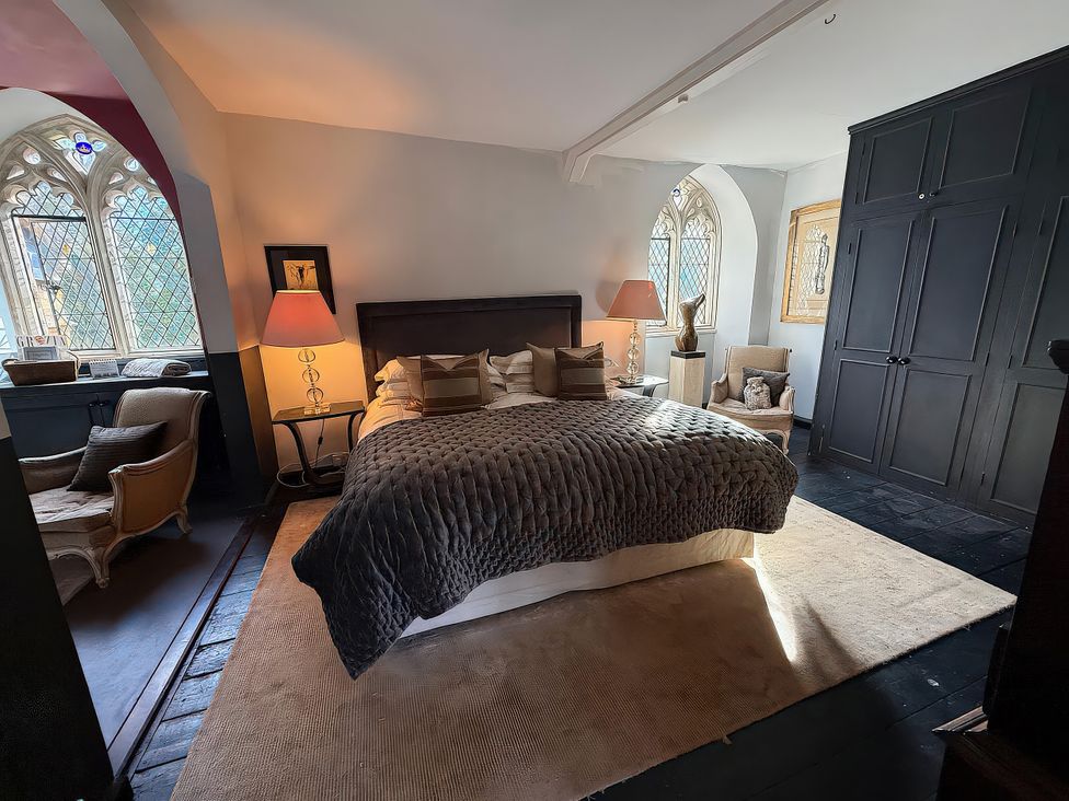 A bedroom with a bed and a lamp at King Ina's Palace in South Petherton