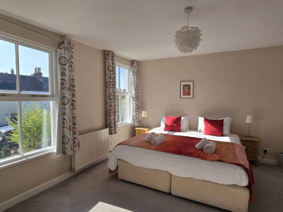 A bedroom with a bed and bedside tables at Bay Tree Cottage in Keswick