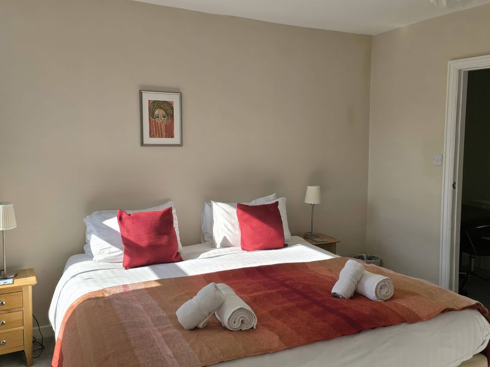 A bedroom with a bed and bedside table at Bay Tree Cottage in Keswick