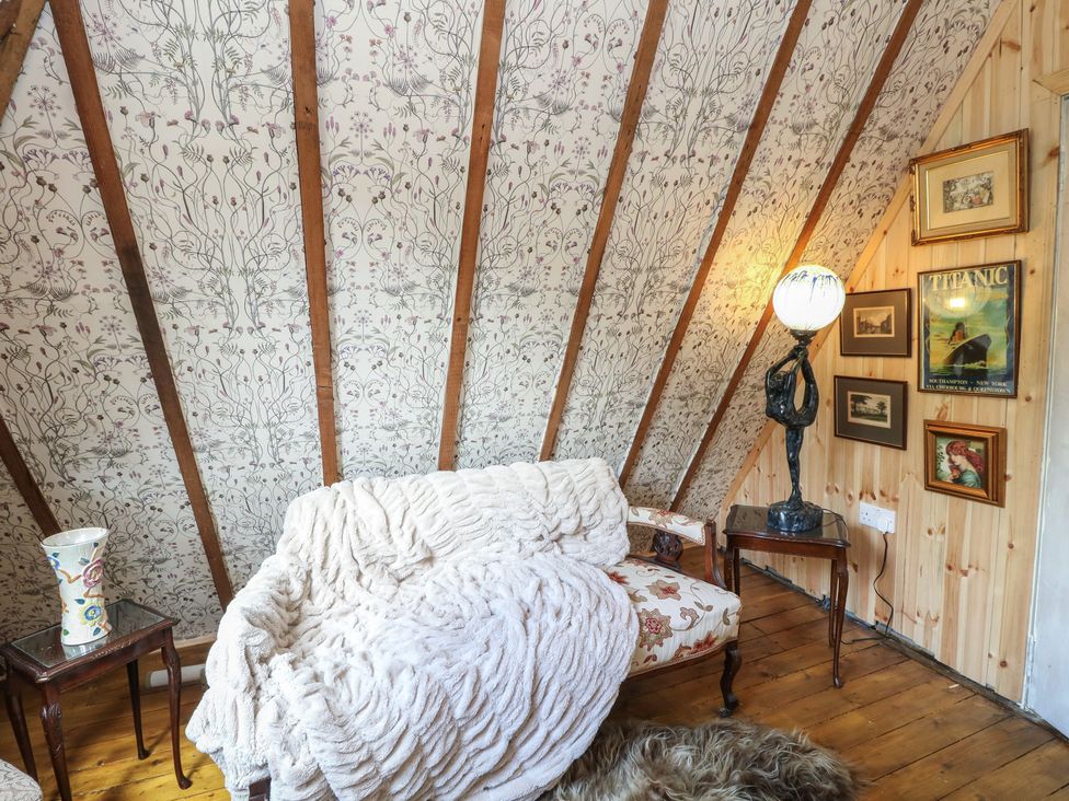 A living room with a sofa and lamp at The Cottage In The Woods, Connel, Argyll & Bute