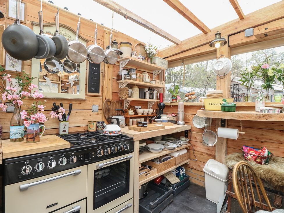 A kitchen with shelves and cookware at The Cottage In The Woods, Connel, Argyll & Bute