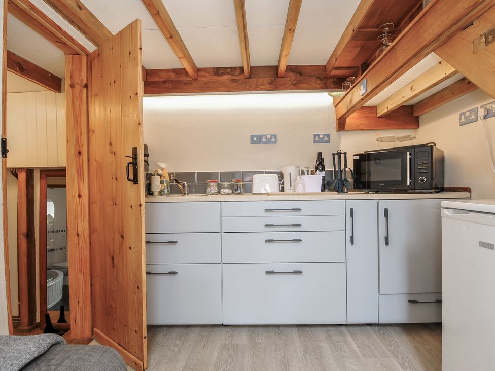 A kitchen with a sink and cabinets at Little Coombe in Trehunist near Liskeard