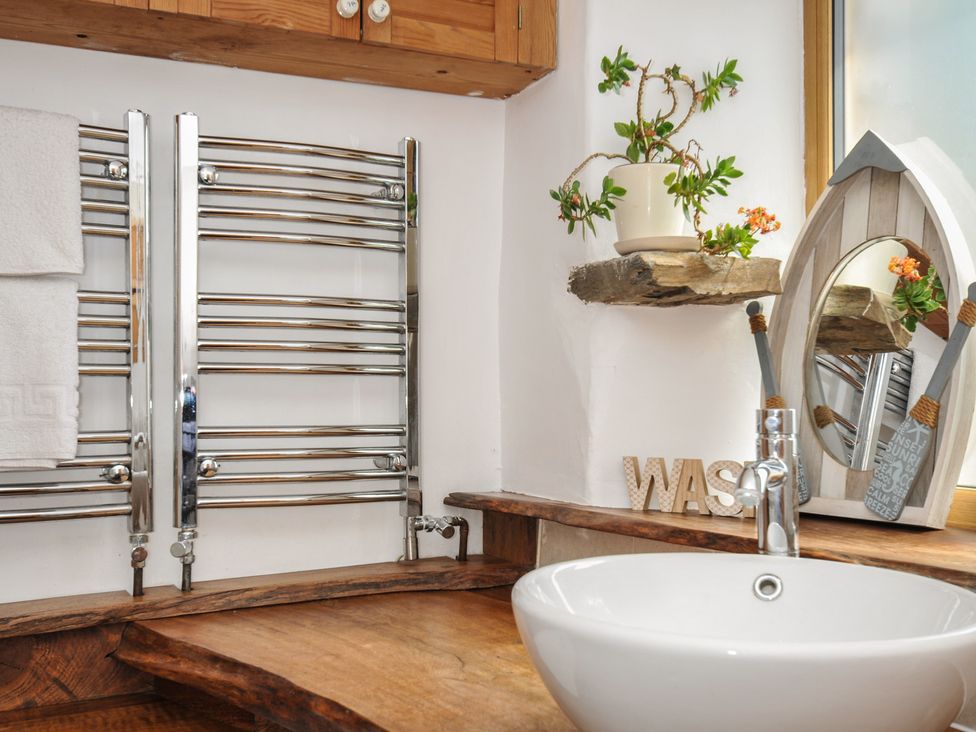 A bathroom with a sink and towel radiator at Little Coombe, Trehunist near Liskeard