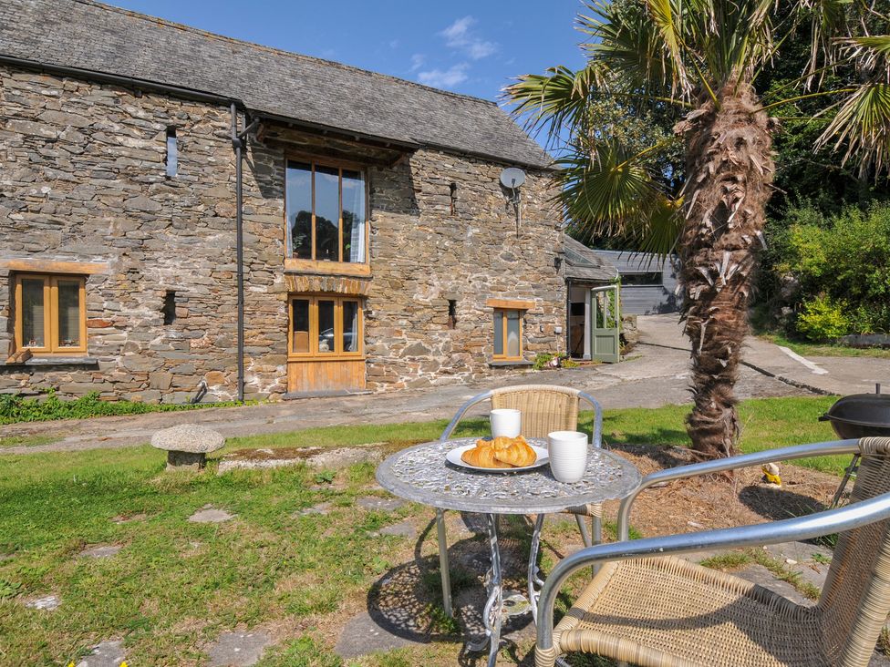 An outdoor seating area with a table and croissants at Little Coombe Trehunist near Liskeard