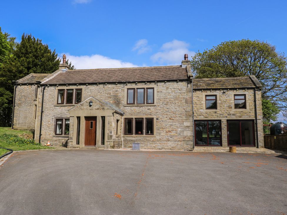 A house with multiple windows and a driveway at Stagwood House in New Mill