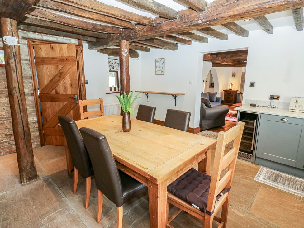 A dining room with a table and chairs at Stagwood House in New Mill