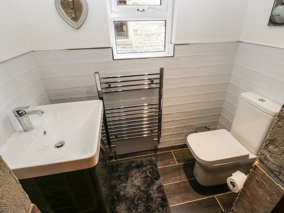 A bathroom with sink and toilet at Stagwood House in New Mill