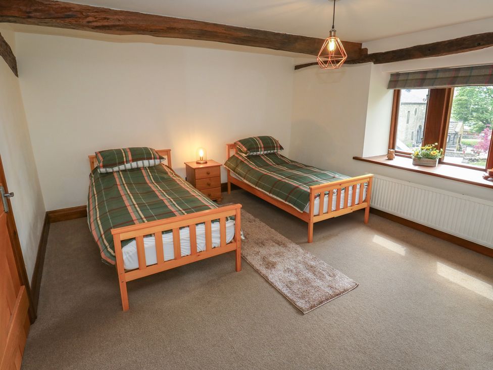 A bedroom with two single beds and a nightstand at Stagwood House New Mill