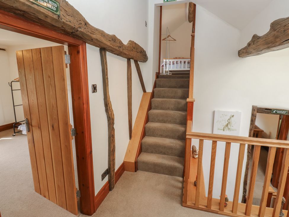 A staircase and door in a hallway at Stagwood House in New Mill