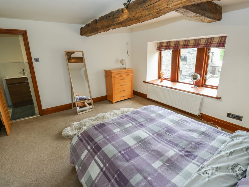 A bedroom with a bed and dresser at Stagwood House New Mill
