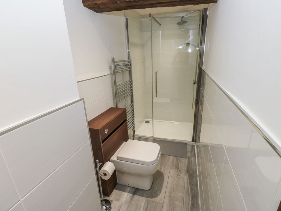 A bathroom with a shower and toilet at Stagwood House in New Mill