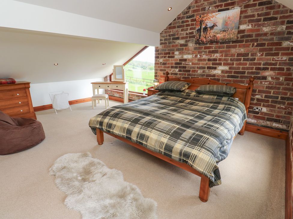A bedroom with a bed and furniture at Stagwood House in New Mill