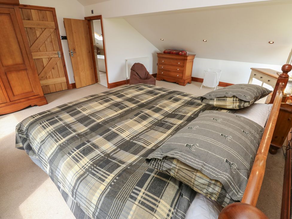 A bedroom with a bed and wardrobe at Stagwood House New Mill