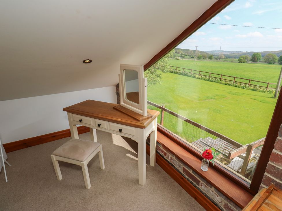 A bedroom with a vanity table and view of a field at Stagwood House in New Mill