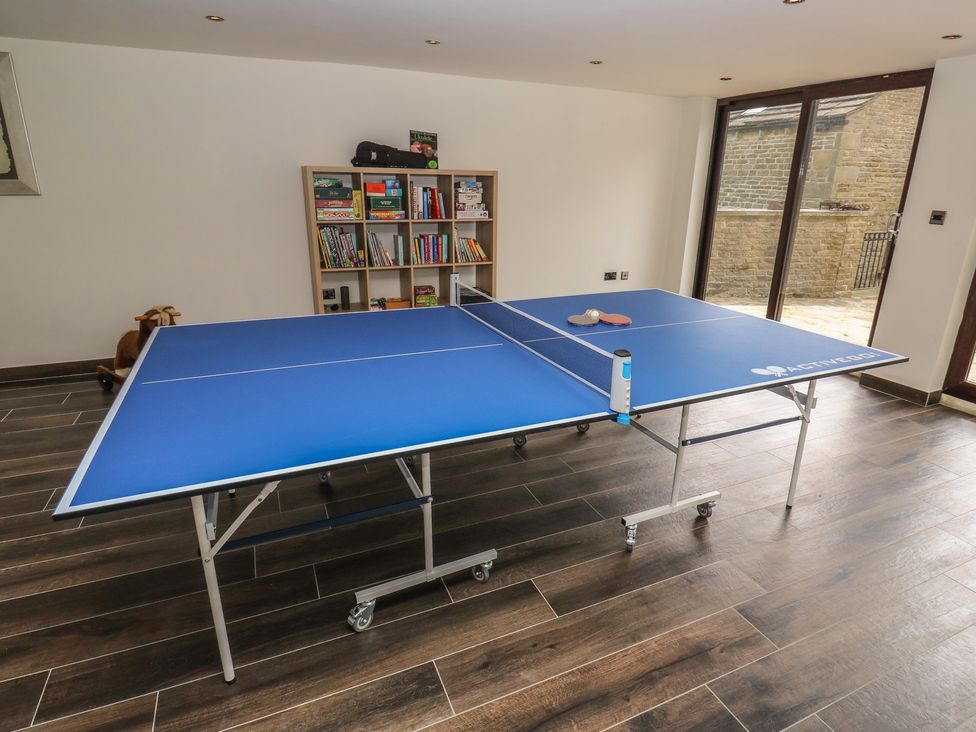 A table tennis table and bookshelf at Stagwood House New Mill