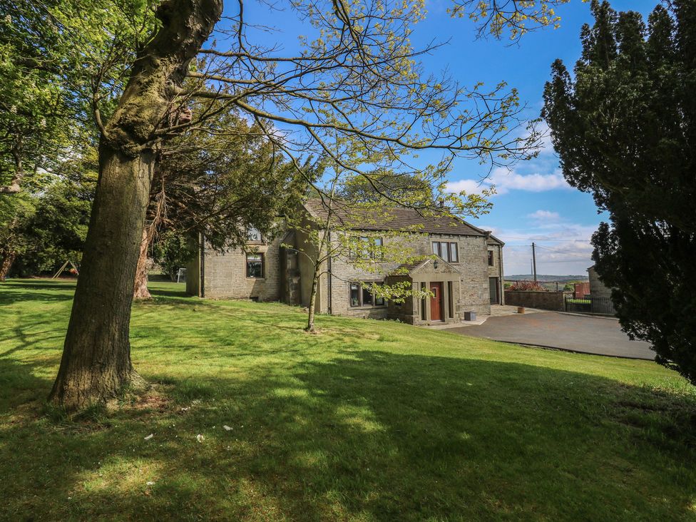 A house with a driveway and trees at Stagwood House New Mill