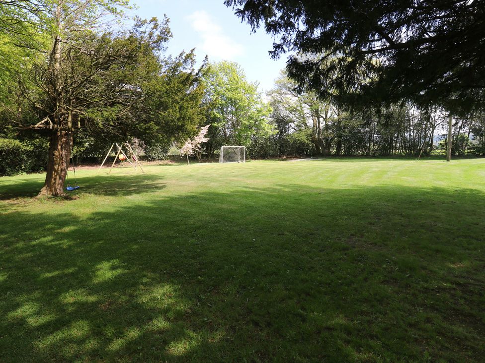 An outdoor area with a swing set and soccer goal at Stagwood House New Mill