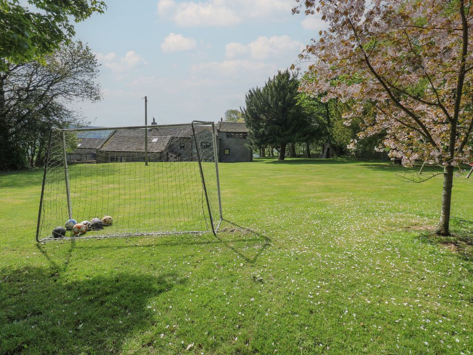 A garden with a goalpost and footballs at Stagwood House in New Mill