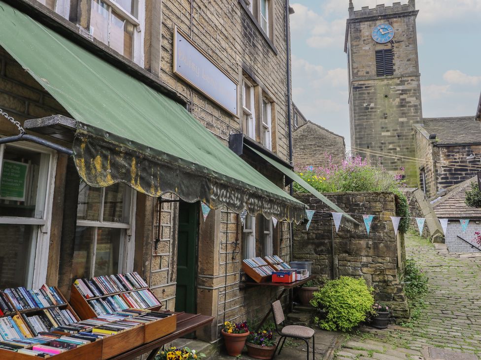 An outdoor area with books displayed near a clock tower at Stagwood House in New Mill