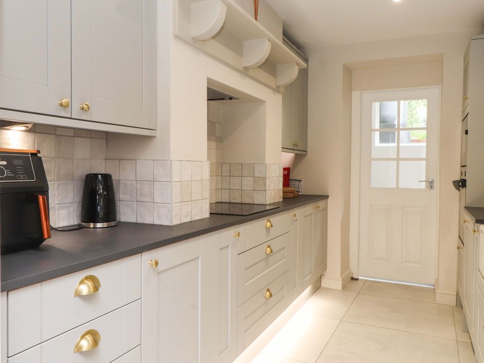 A kitchen with cabinets and appliances at Hendre in Menai Bridge