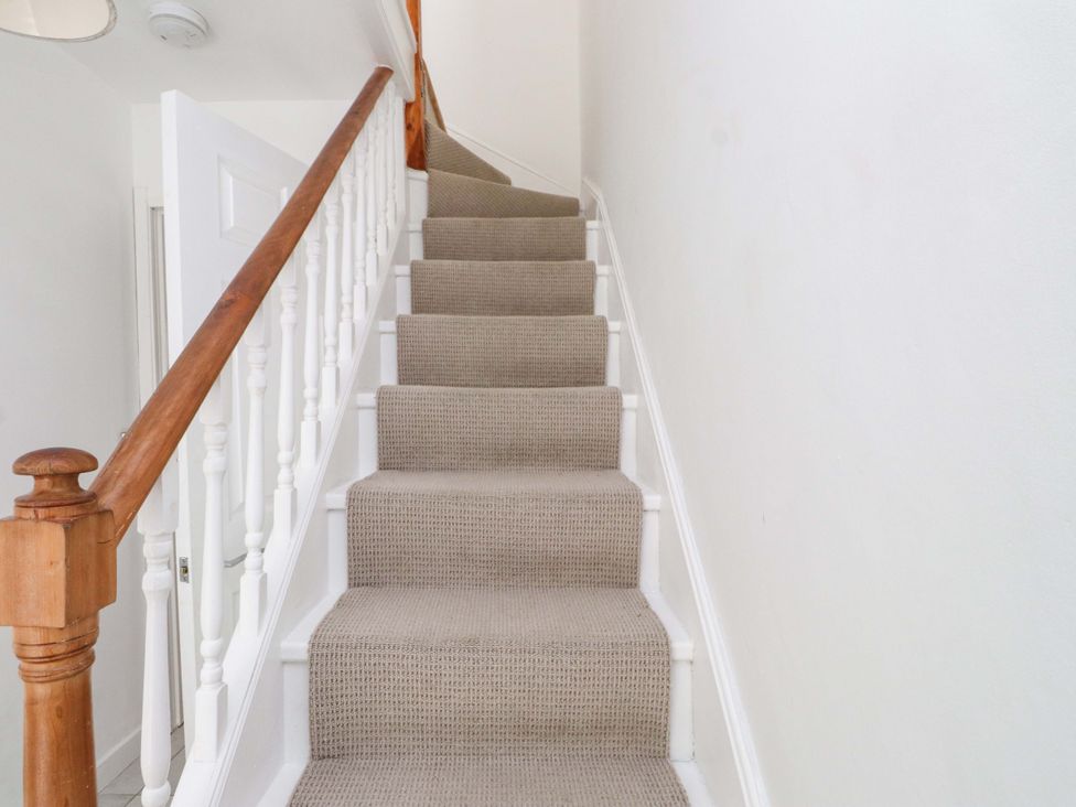 A staircase with carpeted steps at Hendre in Menai Bridge