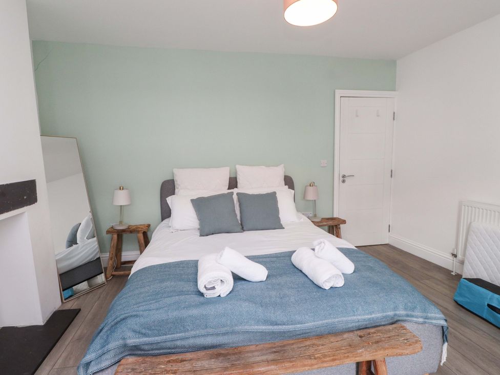 A bedroom with a bed and furniture at Hendre in Menai Bridge