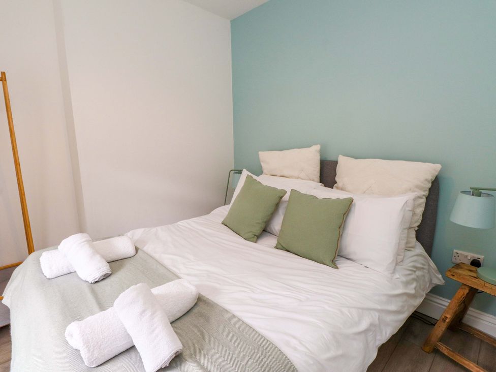 A bedroom with a bed and pillows at Hendre in Menai Bridge