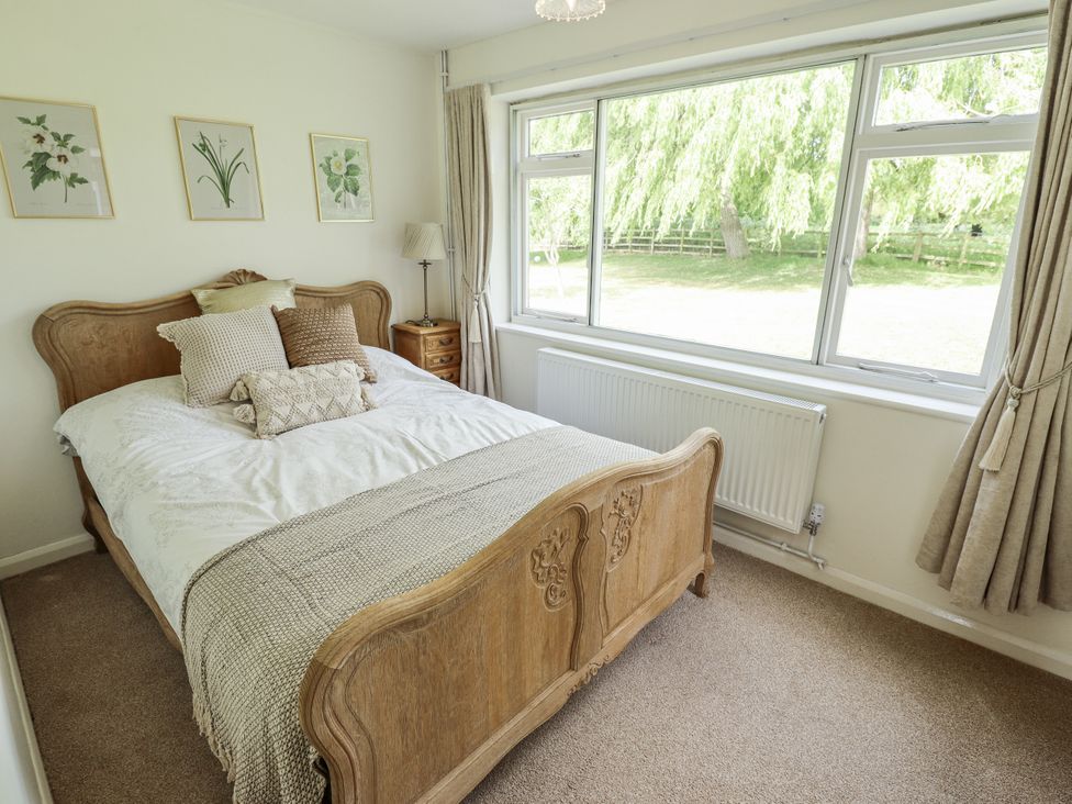A bedroom with a bed and window at Lake View Cottage Well near Alford