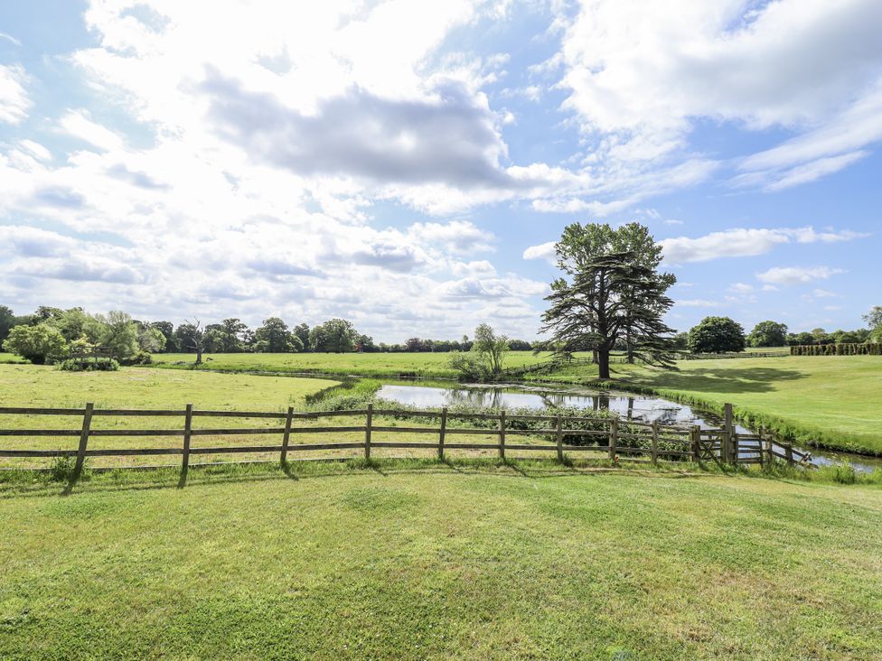 A scenic view of a pond and tree at Lake View Cottage Well near Alford